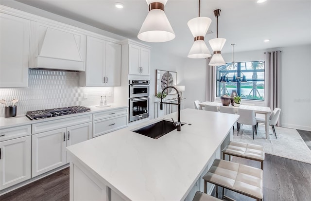 kitchen with custom exhaust hood, backsplash, double oven, a sink, and gas cooktop