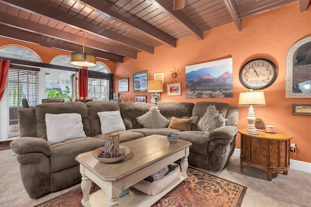 tiled living room featuring beam ceiling, wood ceiling, and baseboards