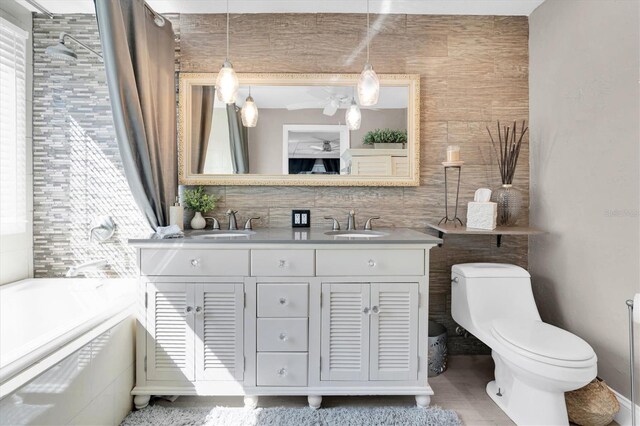 full bath featuring backsplash, a sink, toilet, and tile walls