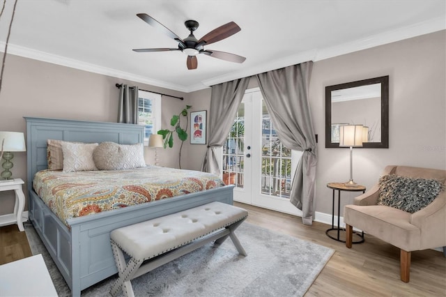 bedroom featuring baseboards, ornamental molding, wood finished floors, access to exterior, and french doors