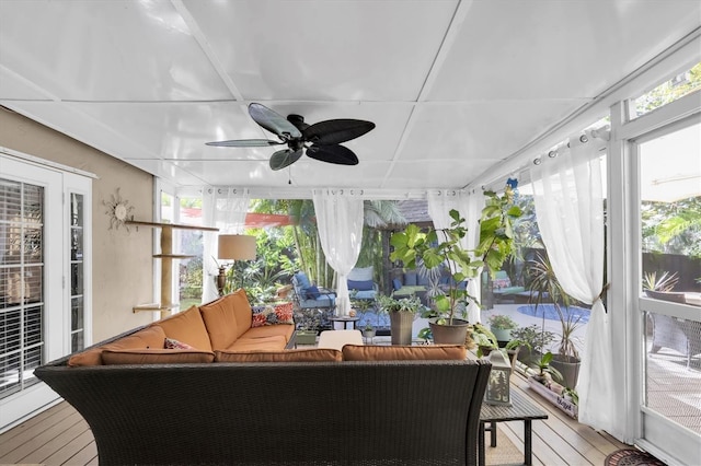 sunroom with a healthy amount of sunlight and ceiling fan