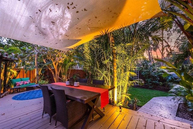 wooden terrace with fence and outdoor dining area