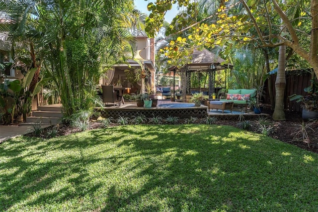 view of yard with outdoor lounge area, fence, a gazebo, and a patio