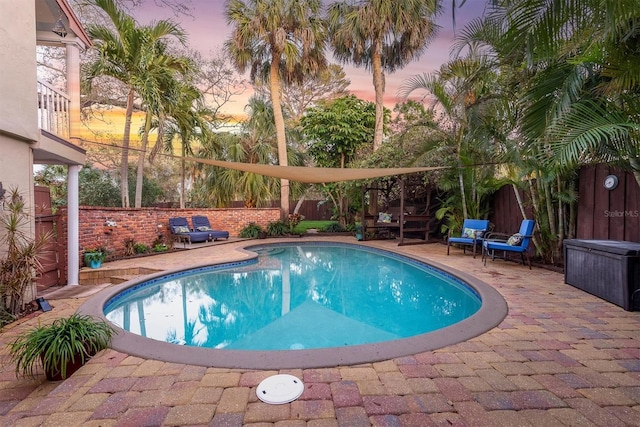 view of pool featuring a patio area, a fenced backyard, and a fenced in pool