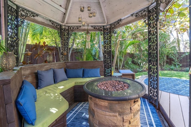 view of patio with an outdoor living space with a fire pit, a fenced backyard, and a gazebo