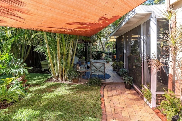 view of yard with a sunroom and a wooden deck