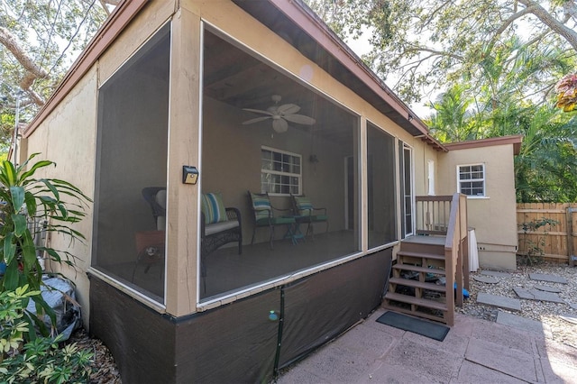 exterior space with a sunroom and fence