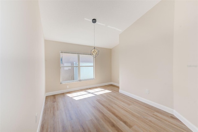 spare room with light wood finished floors and baseboards