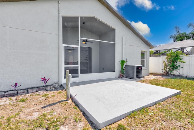 back of house featuring stucco siding, fence, cooling unit, and a patio