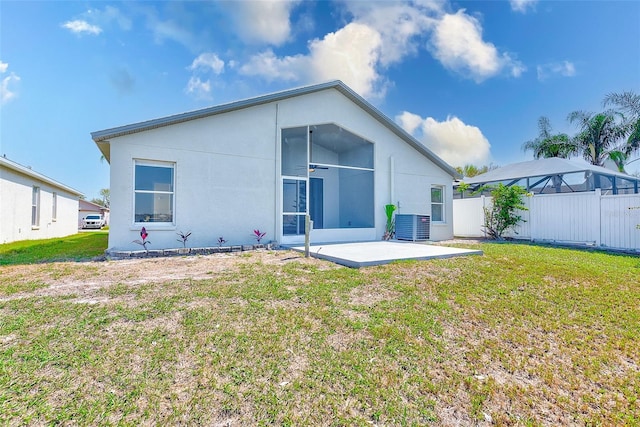 back of property featuring central AC, a lawn, a patio, and fence