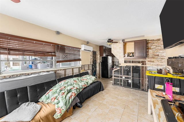 bedroom with a wall unit AC, light tile patterned floors, multiple windows, and freestanding refrigerator