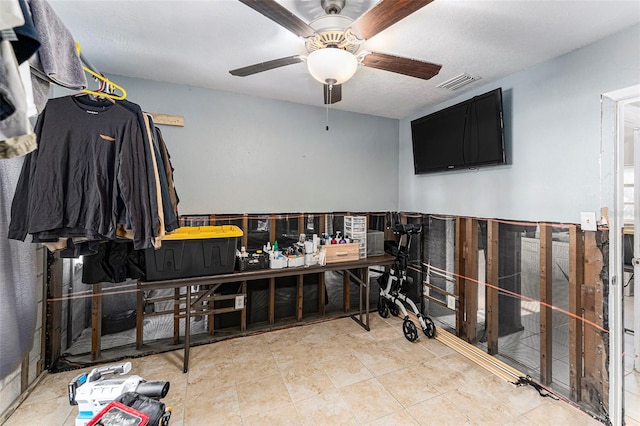 interior space featuring a ceiling fan and visible vents