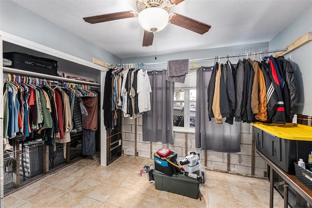 walk in closet with ceiling fan