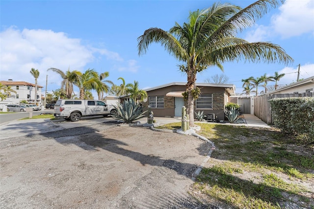 view of front of home with fence and stucco siding