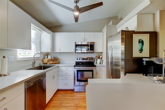 kitchen with a ceiling fan, white cabinets, light countertops, a sink, and stainless steel appliances