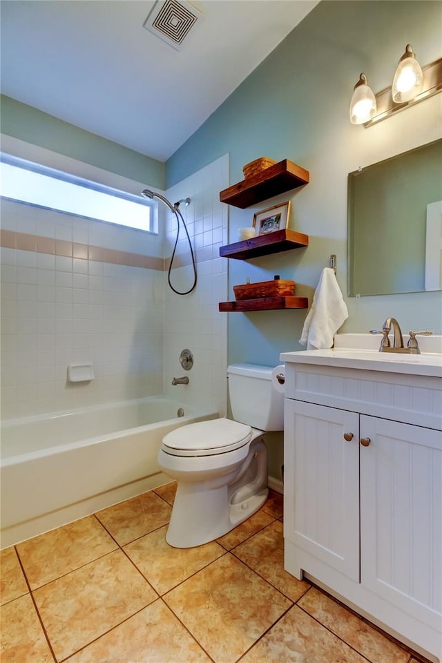 bathroom featuring shower / washtub combination, vanity, visible vents, toilet, and tile patterned floors