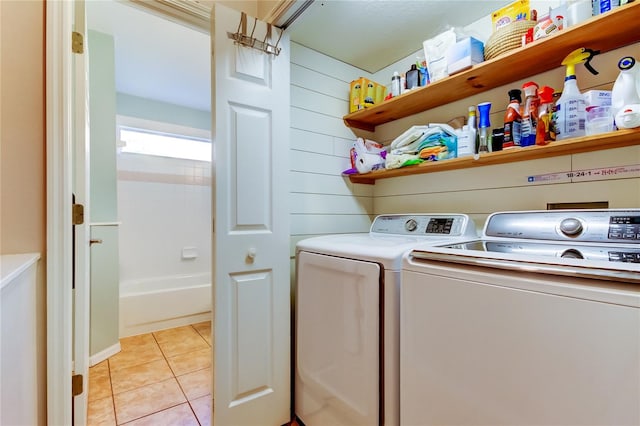 laundry room with light tile patterned floors, independent washer and dryer, and laundry area