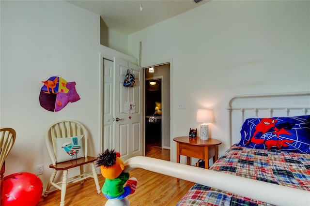 bedroom featuring wood finished floors and baseboards