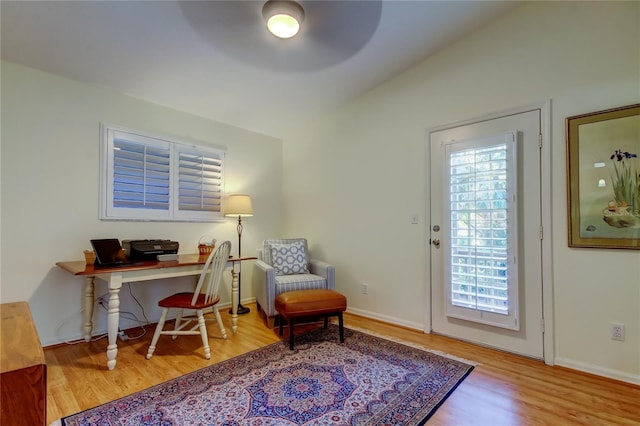 home office with wood finished floors, ceiling fan, and baseboards