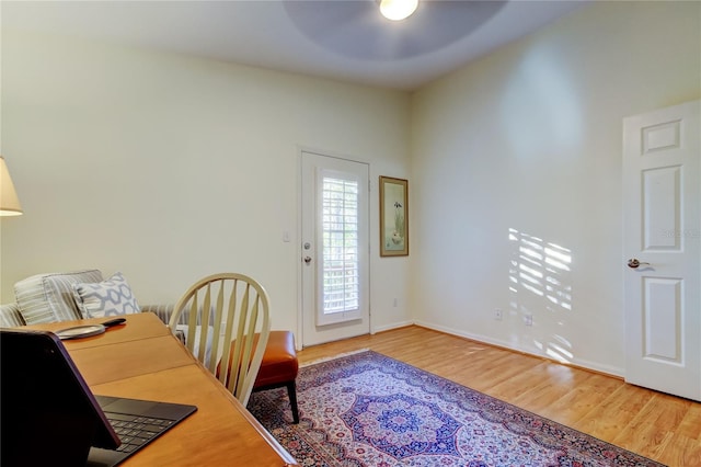 office featuring ceiling fan, baseboards, and wood finished floors