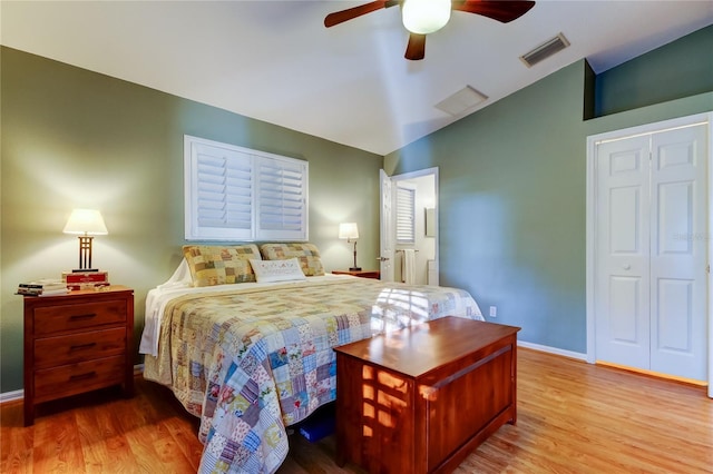 bedroom with visible vents, baseboards, ceiling fan, vaulted ceiling, and wood finished floors