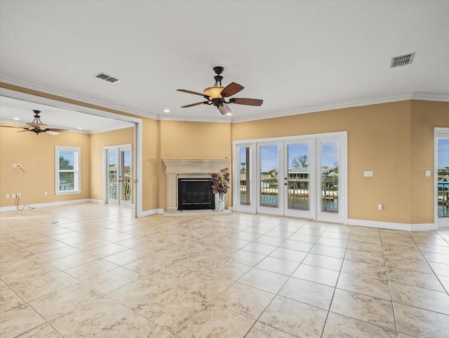 unfurnished living room featuring light tile patterned flooring, a glass covered fireplace, visible vents, and a ceiling fan