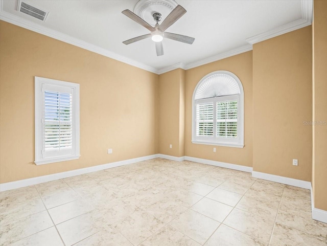 tiled empty room with baseboards, a ceiling fan, visible vents, and crown molding