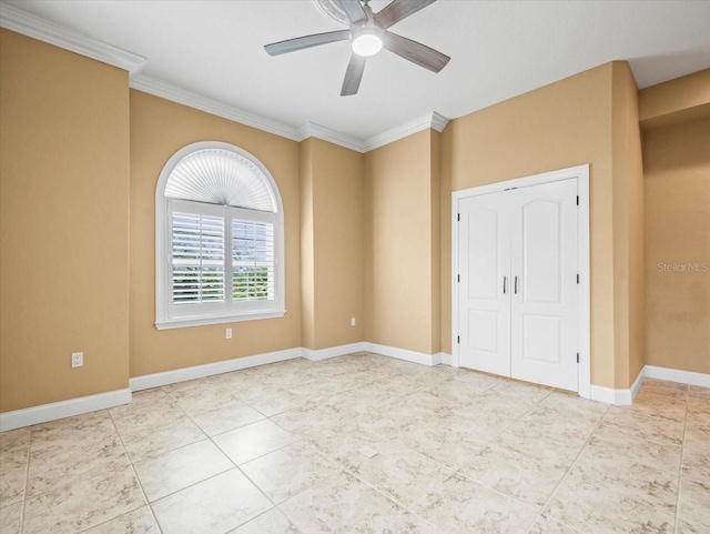 spare room featuring baseboards, a ceiling fan, and ornamental molding