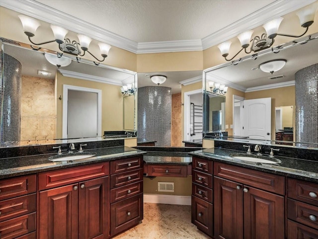 bathroom featuring ornamental molding, a sink, and visible vents