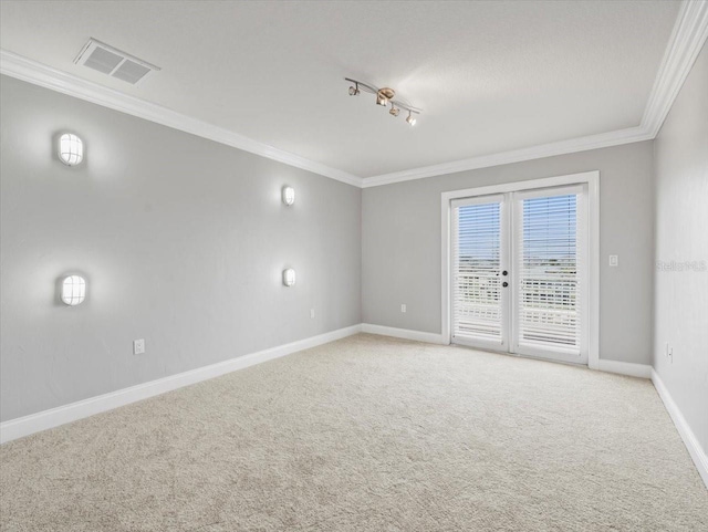 unfurnished room featuring light colored carpet, visible vents, baseboards, french doors, and ornamental molding