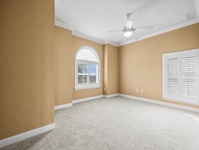 unfurnished room with carpet, baseboards, ceiling fan, and crown molding