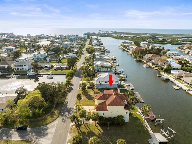 drone / aerial view featuring a water view and a residential view