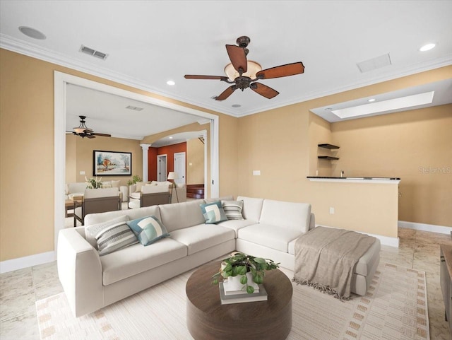 living area featuring visible vents, crown molding, arched walkways, and baseboards