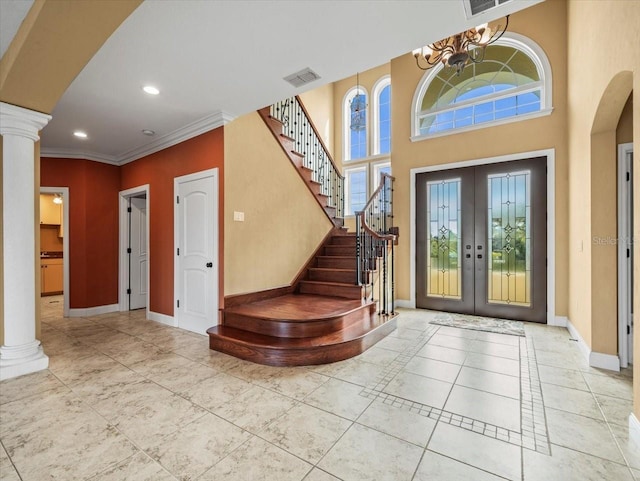 tiled entryway with baseboards, plenty of natural light, and ornate columns