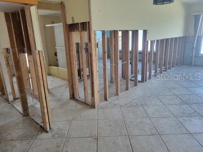 hall with light tile patterned floors