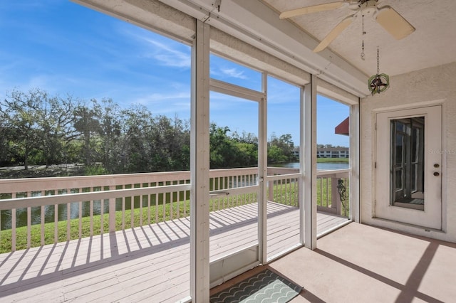 unfurnished sunroom with ceiling fan