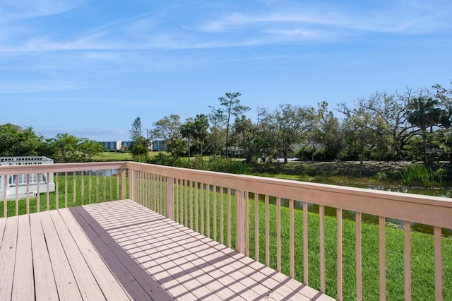 wooden terrace featuring a yard