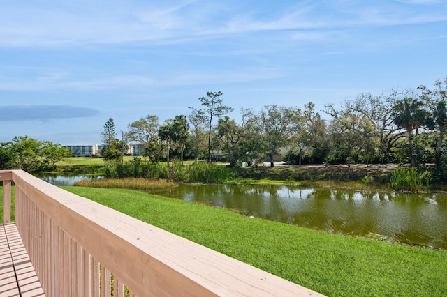 exterior space with a water view and a lawn