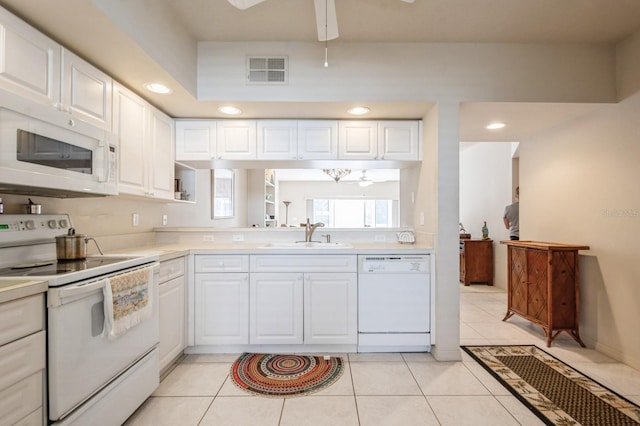 kitchen featuring light countertops, visible vents, a sink, ceiling fan, and white appliances