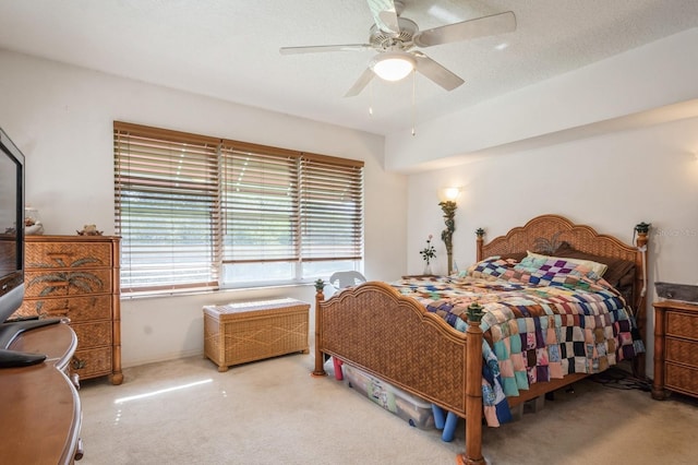 bedroom with carpet, a textured ceiling, and a ceiling fan