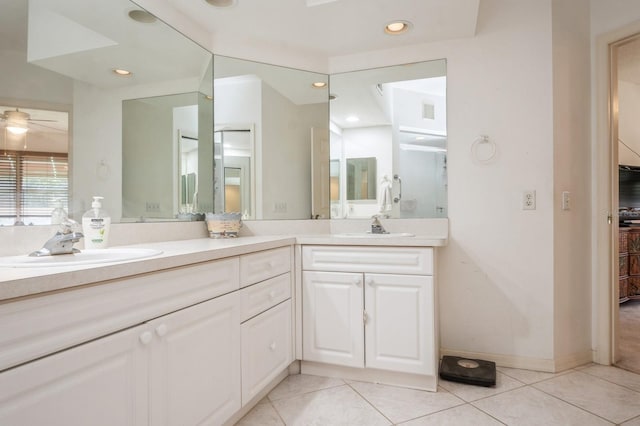 full bathroom featuring double vanity, tile patterned flooring, and a sink