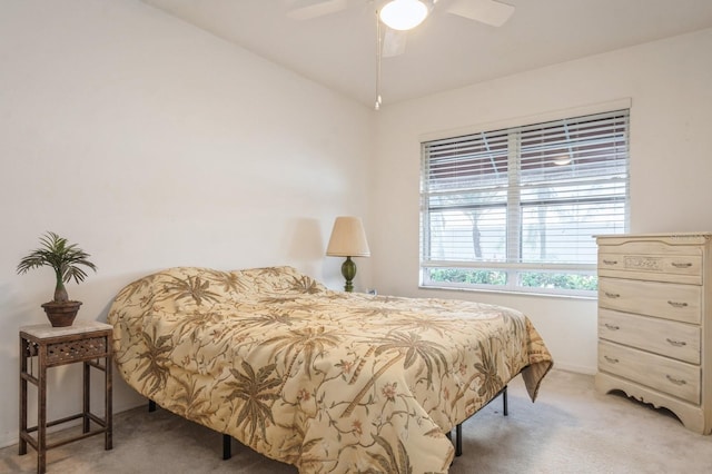 bedroom featuring light carpet, ceiling fan, and vaulted ceiling