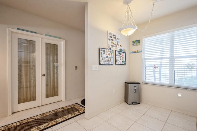 interior space featuring french doors and light tile patterned floors