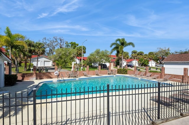 pool featuring fence and a patio