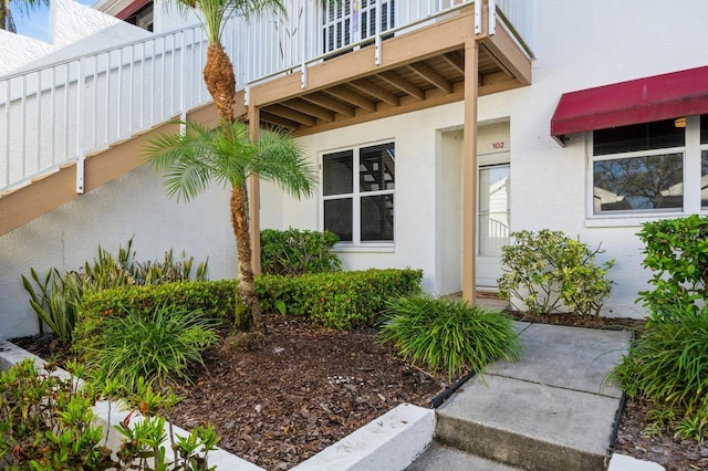 entrance to property featuring stucco siding