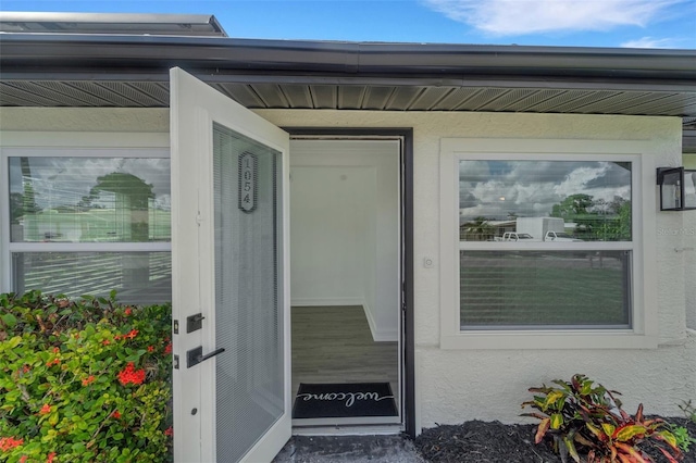 doorway to property with stucco siding