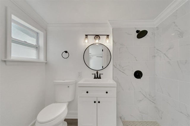 full bathroom with toilet, vanity, baseboards, tiled shower, and crown molding