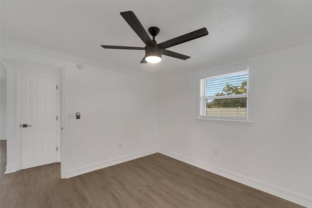 unfurnished room with ornamental molding, a ceiling fan, baseboards, and wood finished floors