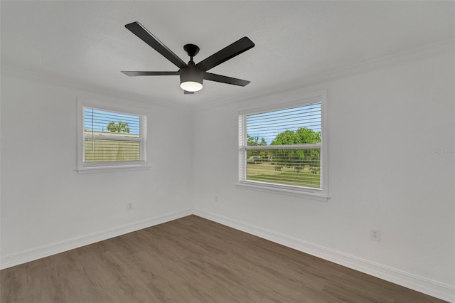 unfurnished room with dark wood-style floors, plenty of natural light, and baseboards