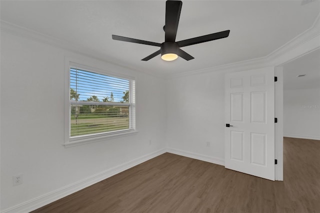 empty room featuring baseboards, ceiling fan, wood finished floors, and crown molding